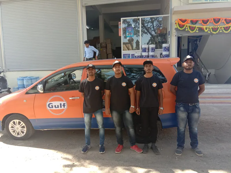 Promotion team standing beside a Gulf branded car