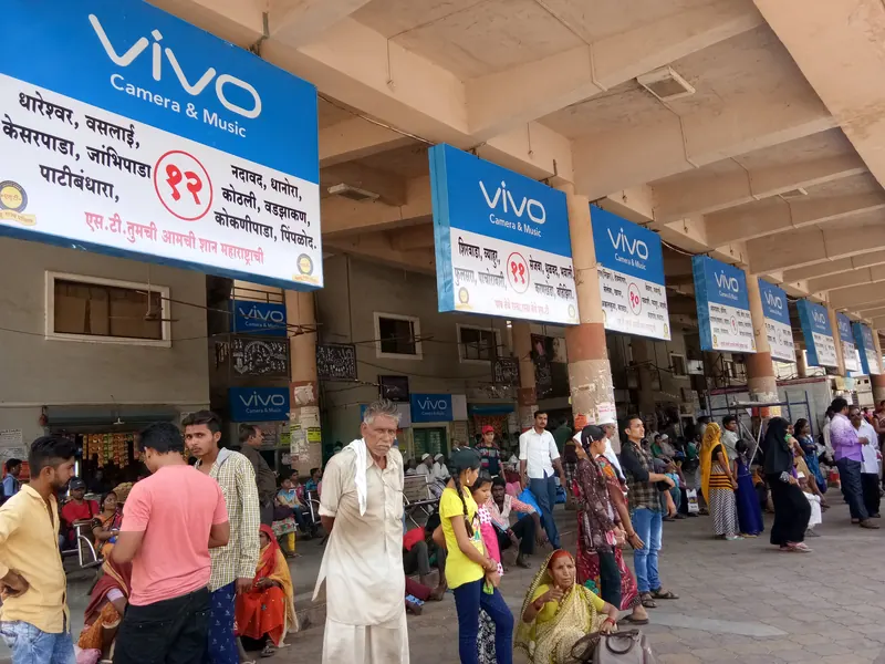 vivo display boards hanging above a busy bus stand platform