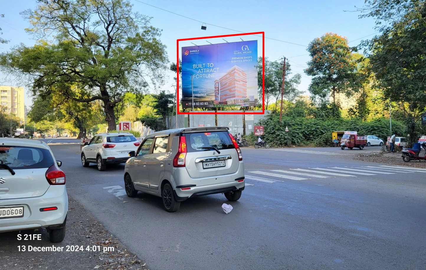 Gujral Arcade hoarding billboard on a Nashik road