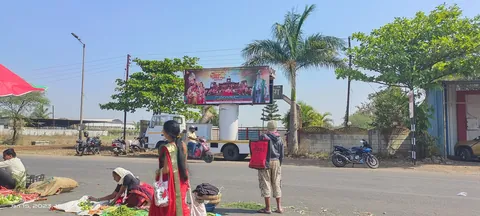 Roadside hoarding beside a busy market road