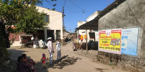 Painted tractor advertisement on the wall of a village building