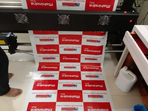 Mahindra backdrop flex coming off a large-format printer