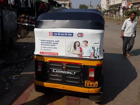 Rear view of an auto rickshaw branded with an HDFC Bank advertisement